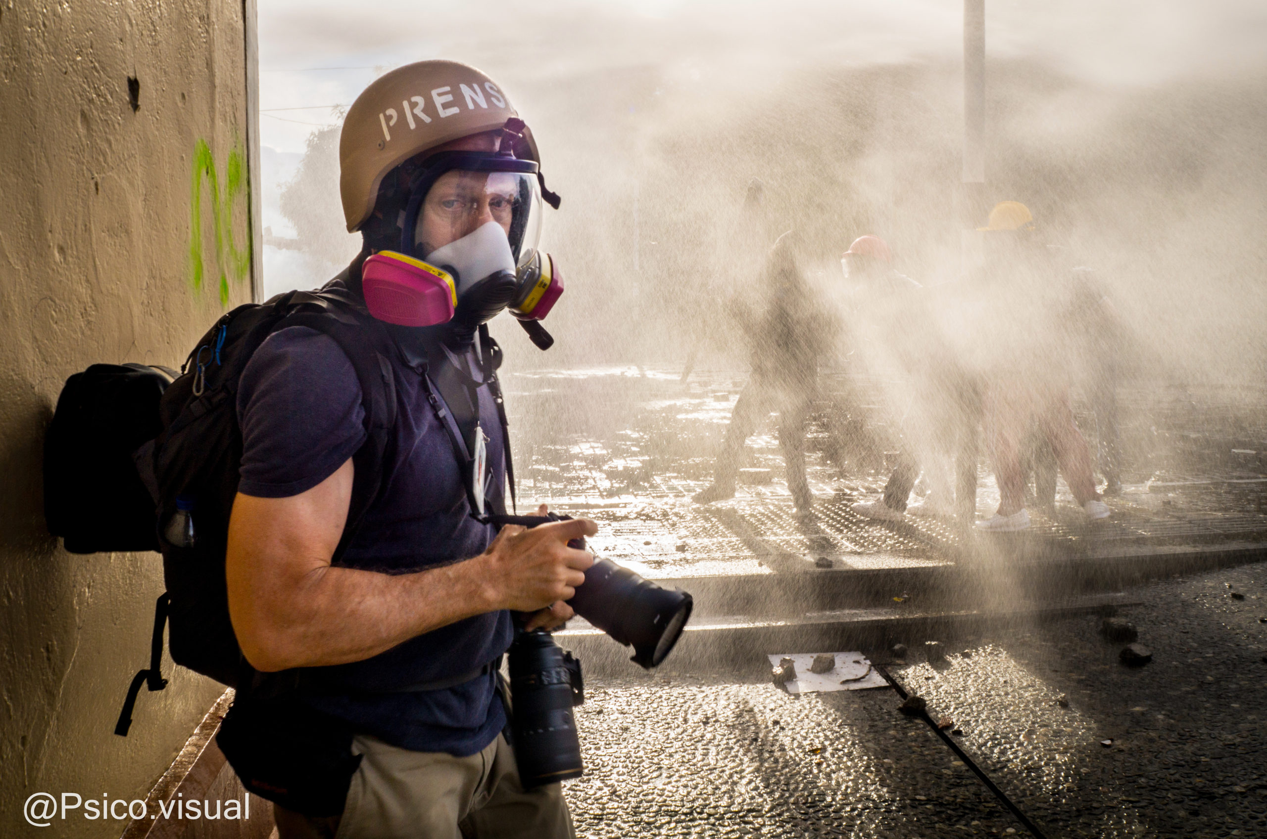 Chris Horn '84 photographed on the job covering political and social unrest in Colombia (Photo provided by Chris Horn)