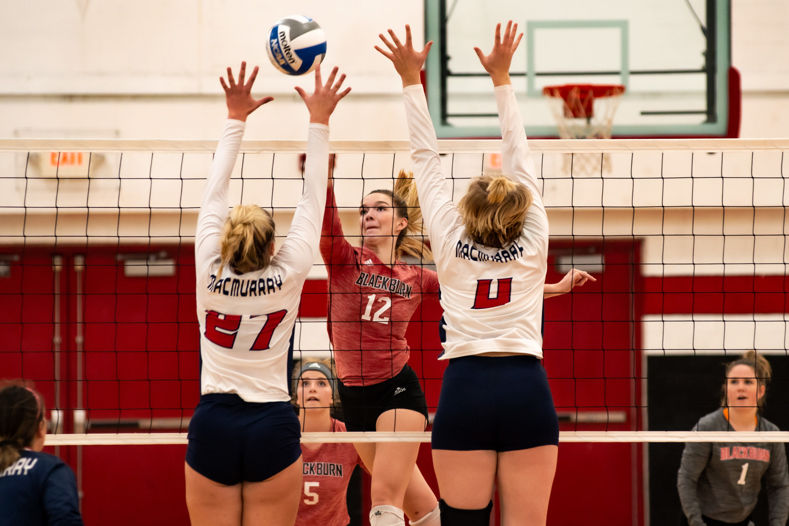 Blackburn Volleyball student-athlete tapping the ball into the adversary team's zone.