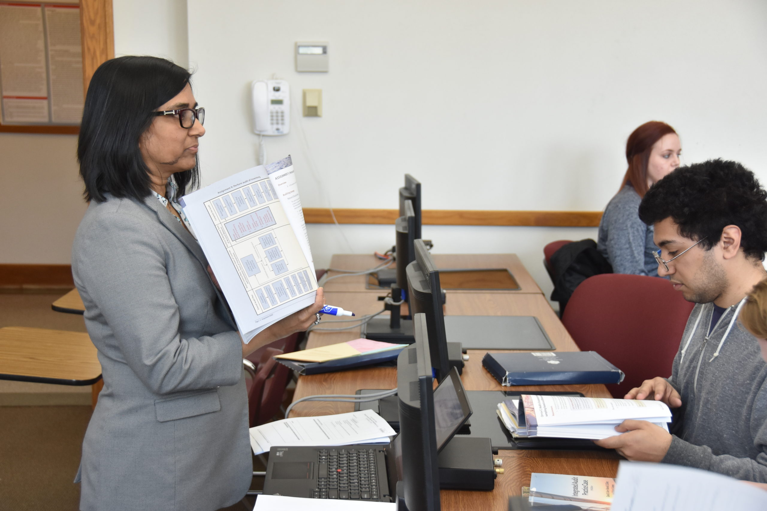 Blackburn Accounting professor, Rashida Kadiani, showing the content of her book to the class.