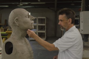 Bob Huber smoothing a sculpture