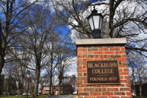 Close-up shot of the right pillar on the South Entrance to campus. The shot is mainly focused on a plaque with the words "Blackburn College. Founded 1837." on it.