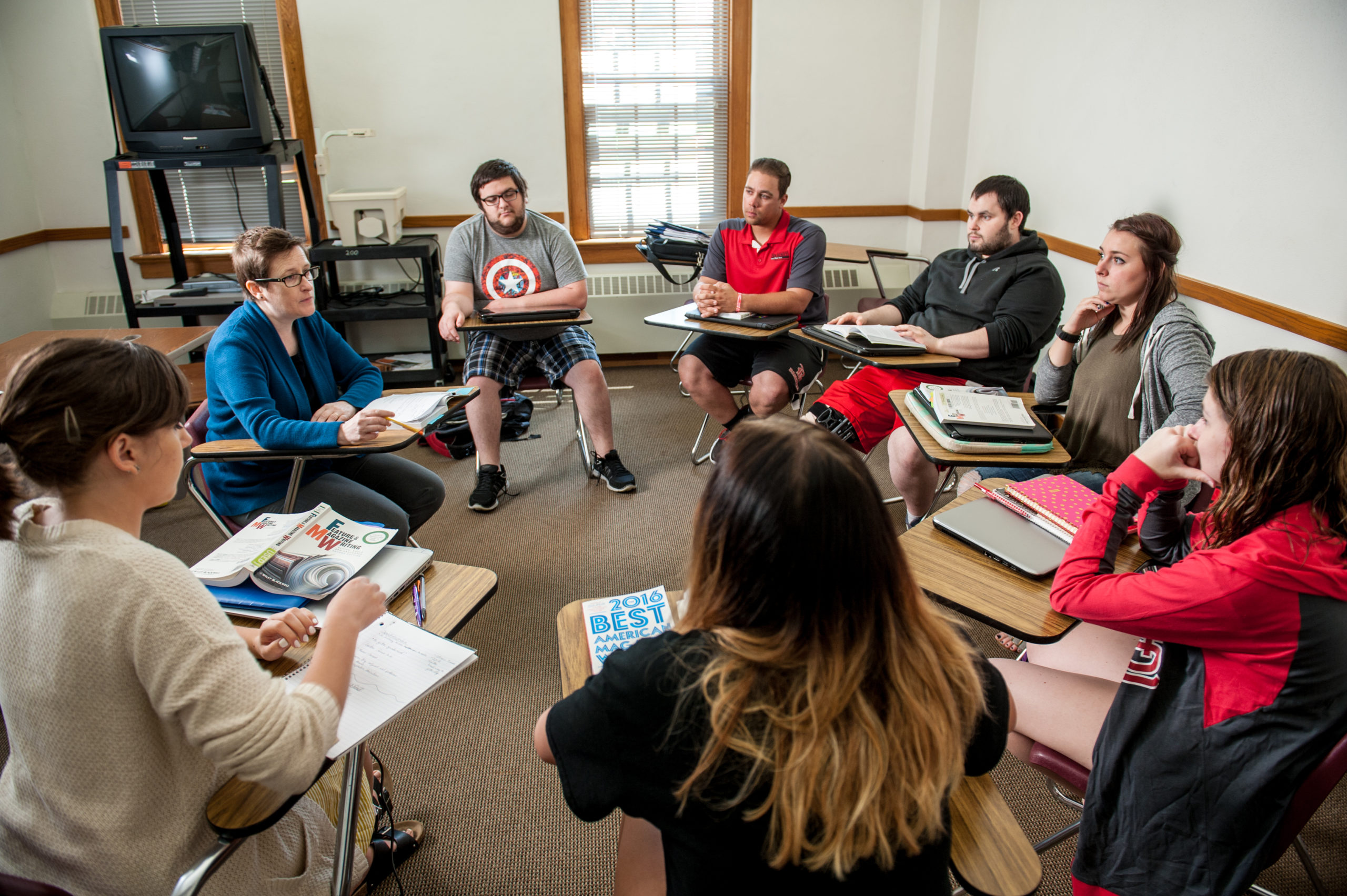 Blackburn Communications professor sitting along with her students in a circular formation.
