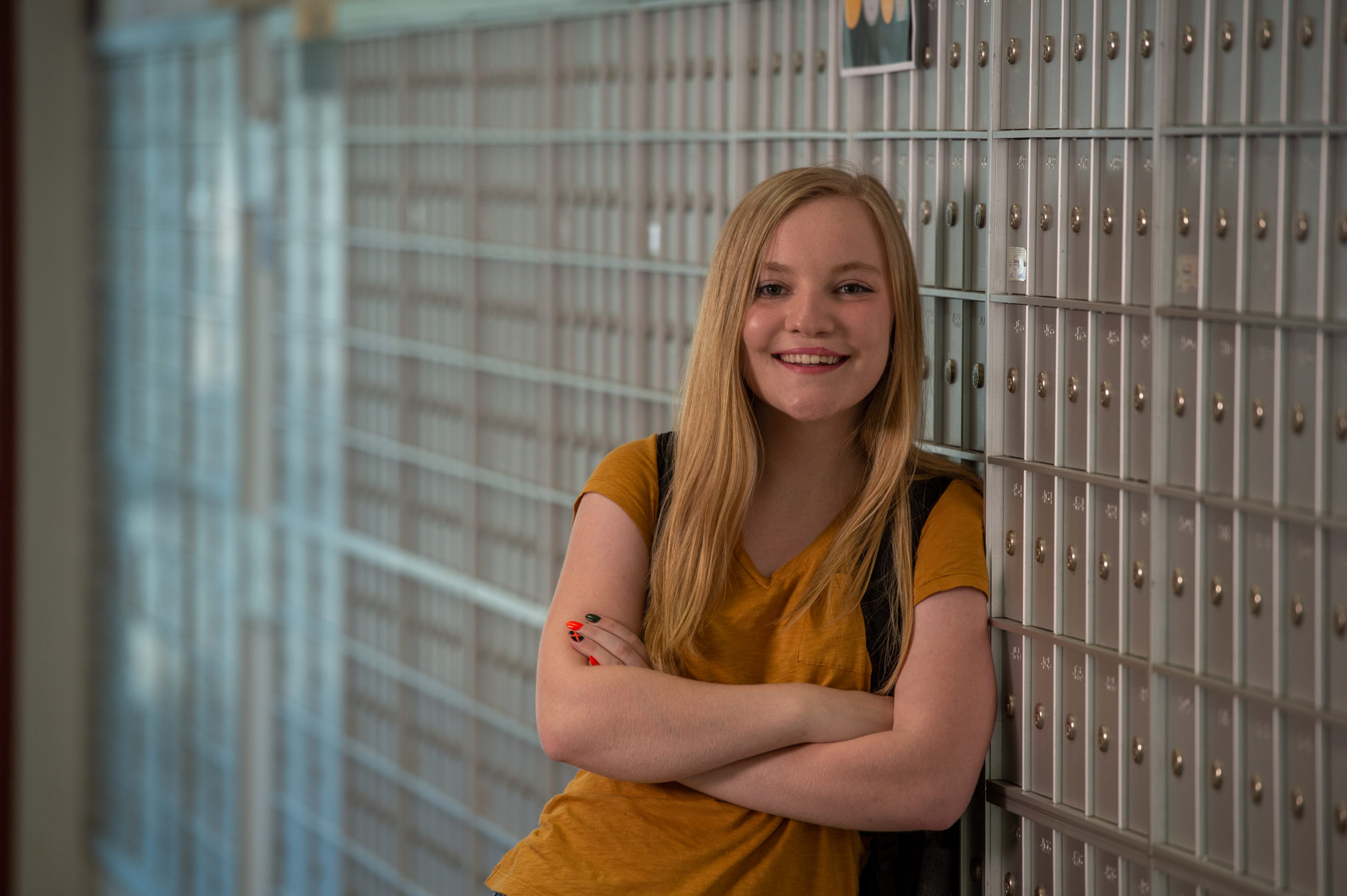 Blackburn student posing for a picture by the mailroom in the Demuzio Campus Center.