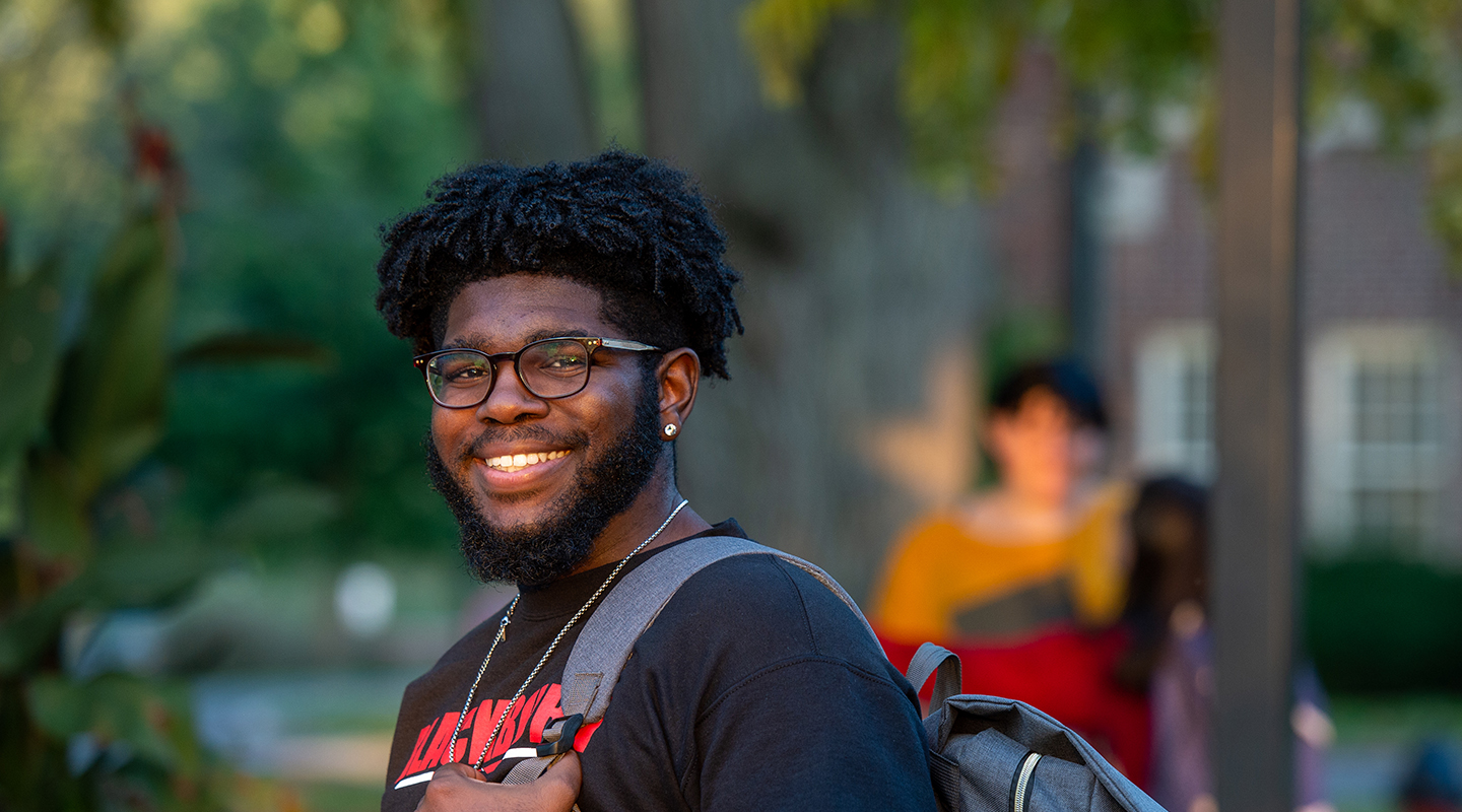 Shot of Blackburn student, Kionte Baker, staring at the camera as he walks through campus.