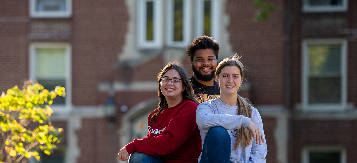 Three Blackburn students posing in front of Butler Hall.