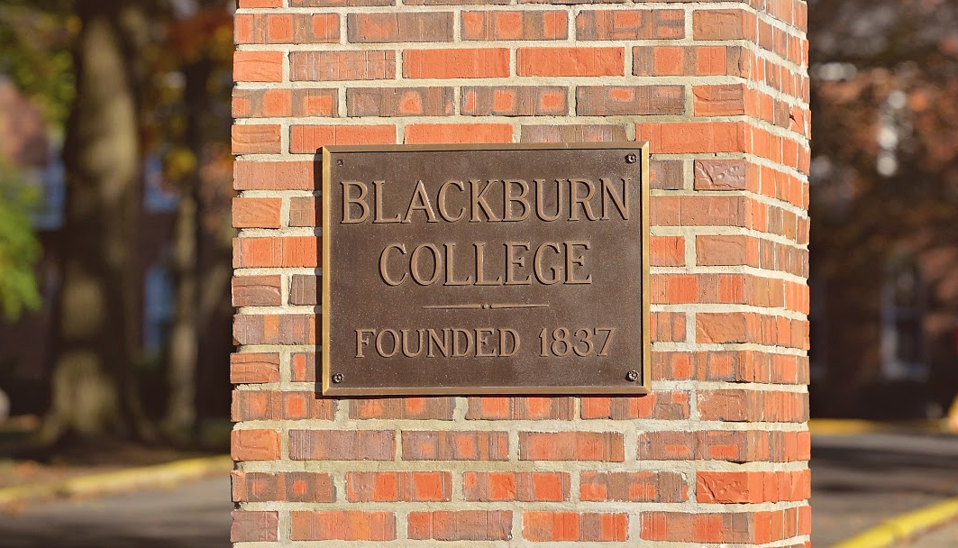Close-up shot of the sign at the entrance to campus.