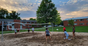 Blackburn students playing sand volleyball at the North-Graham's patio.
