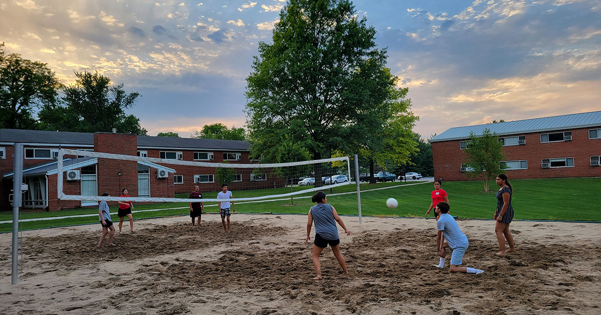 Blackburn students playing sand volleyball at the North-Graham's patio.