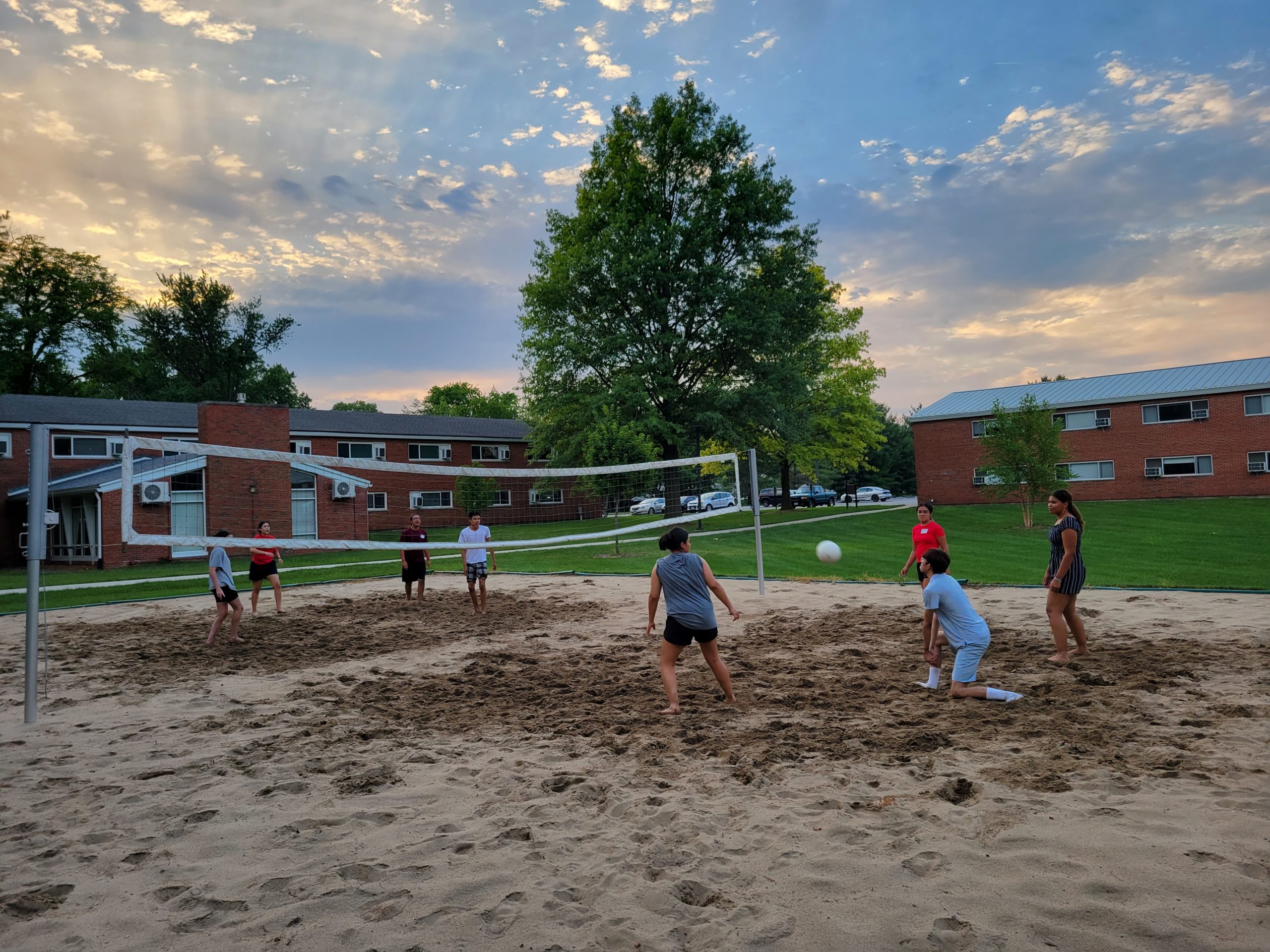 Blackburn students playing sand volleyball at the North-Graham's patio.