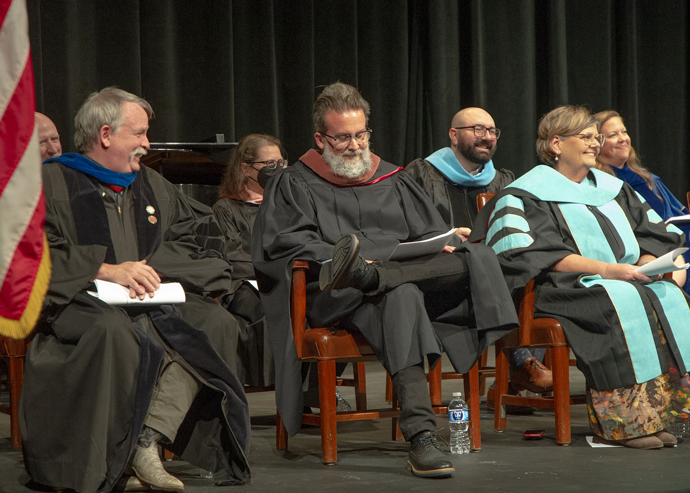Blackburn professors James Bray Jr., Craig Newsom, and Cindy Carlson Rice seated during an award ceremony.