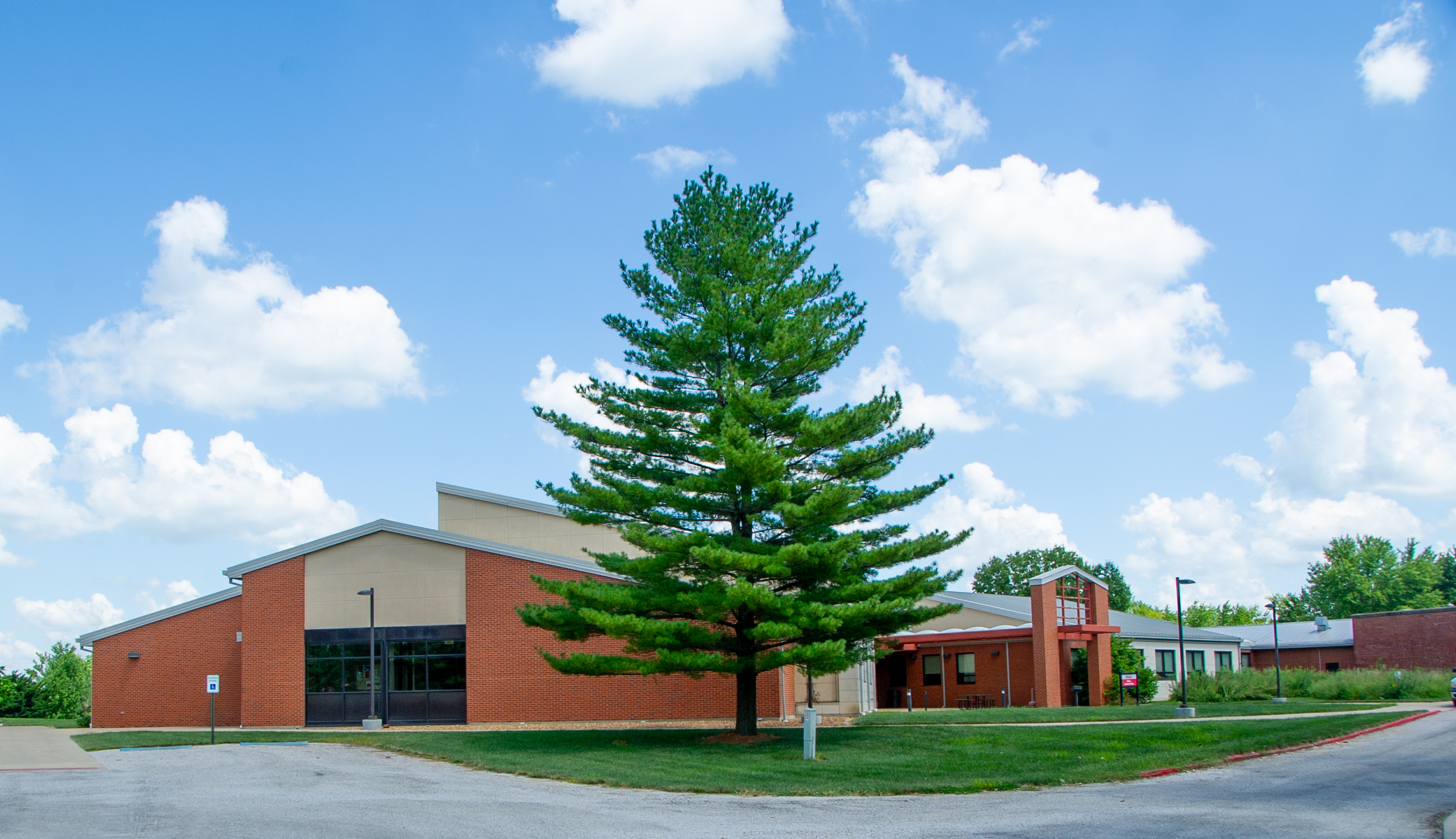 Wide view of Mahan Science Building and its huge Pine tree.