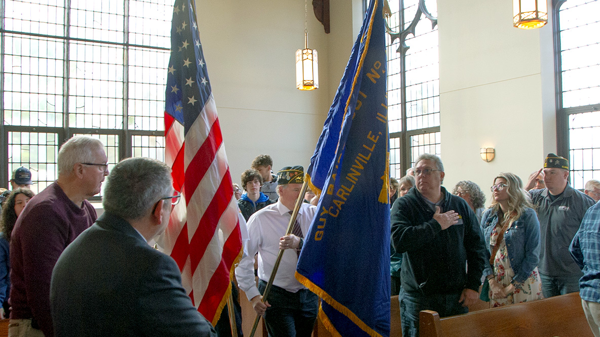 Blackburn's 2022 Veterans Day Convocation, held in Clegg Chapel, as the color guard carries the Carlinville IL American Legion flag and the United States flag down the aisle at the beginning of the ceremony