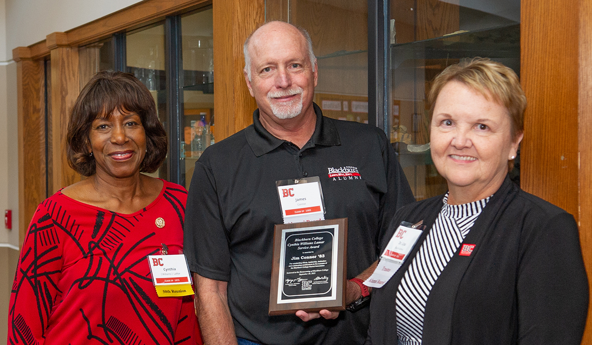 Three Blackburn College Alumni pose at the Awards Luncheon