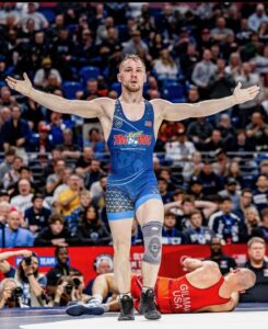 Spencer Lee, olympic freestyle wrestler, gestures with arms wide open to the crowd