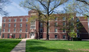 Exterior, brick building with sidewalk leading to front doors - Butler Hall, residence hall