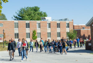 People walking Blackburn's campus in front of Jewell Hall