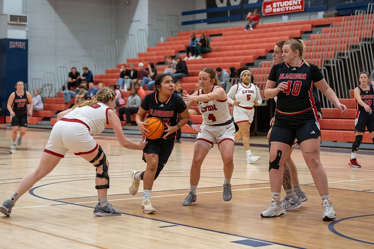 Women playing basketball on a court, Blackburn's Women's Basketball Team faces Lyon College in Arkansas