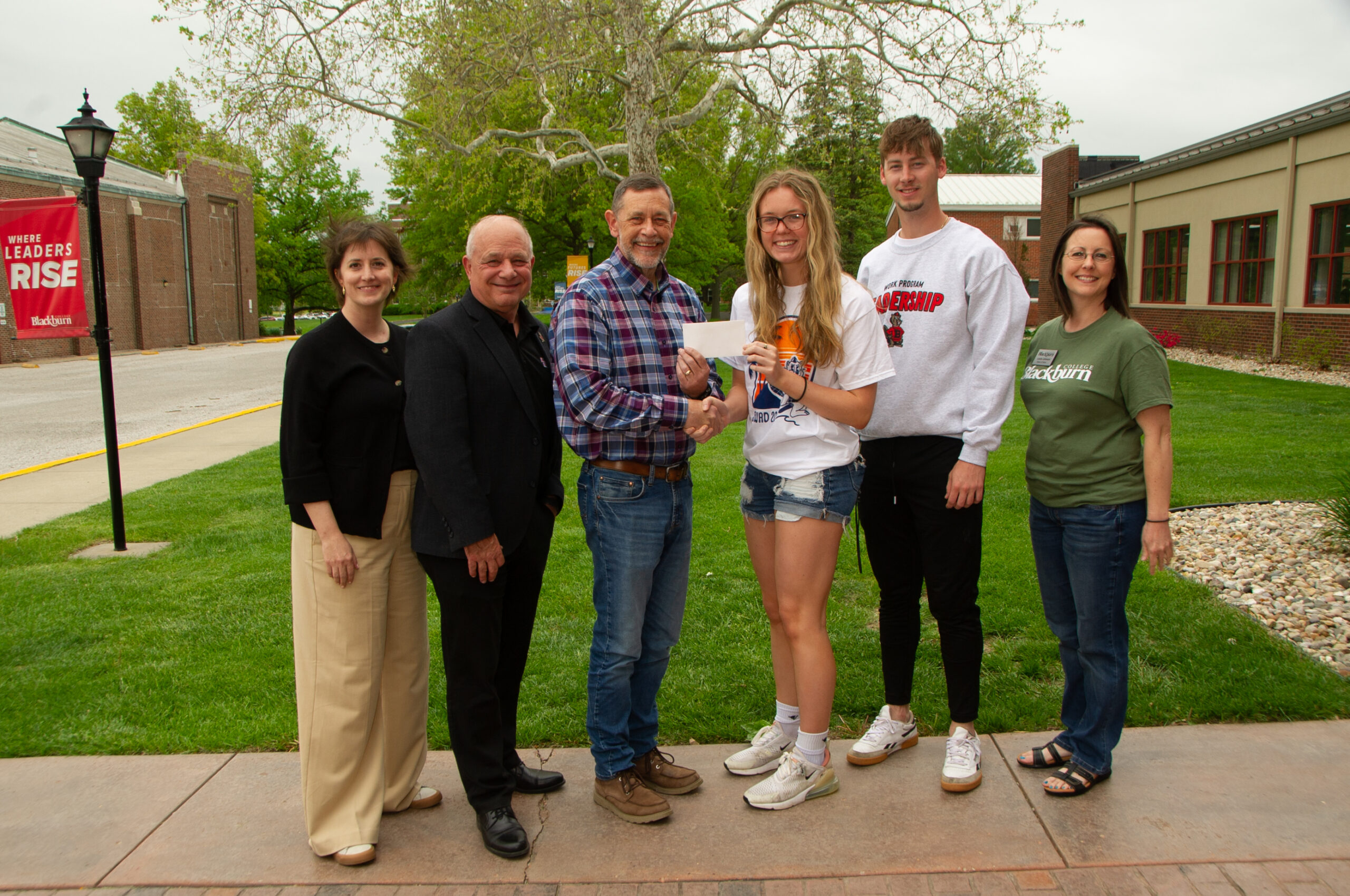 Work Program coordinators and individuals involved in developing the program are shown receiving the gift from State Farm Representative Mr. Richard Oswald.