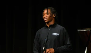 Darius Duff stands on stage and addresses the large crowd after the surprise announcement that he was Student Marshal