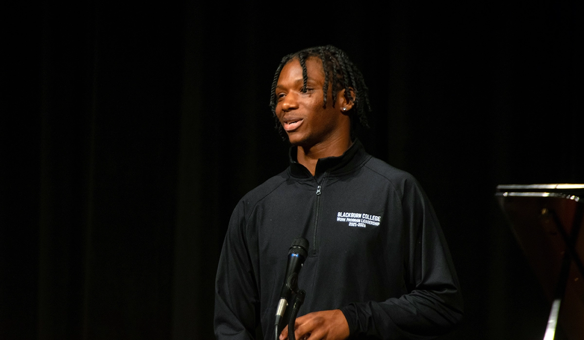 Darius Duff stands on stage and addresses the large crowd after the surprise announcement that he was Student Marshal