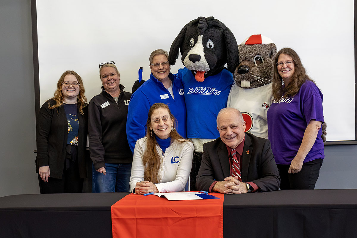Blackburn and Lewis and Clark representatives and mascots sign agreement at February event