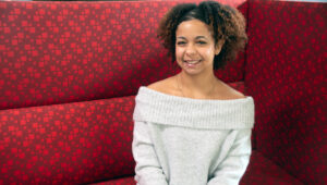 Gabriela Solis sitting on a red couch