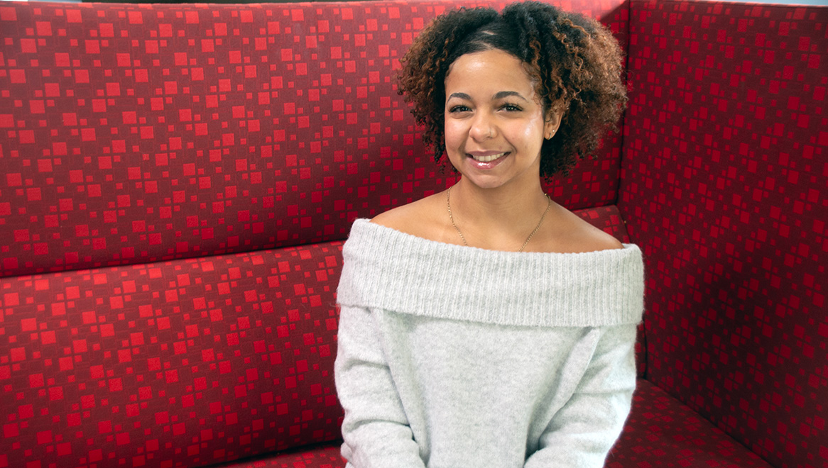 Gabriela Solis sitting on a red couch