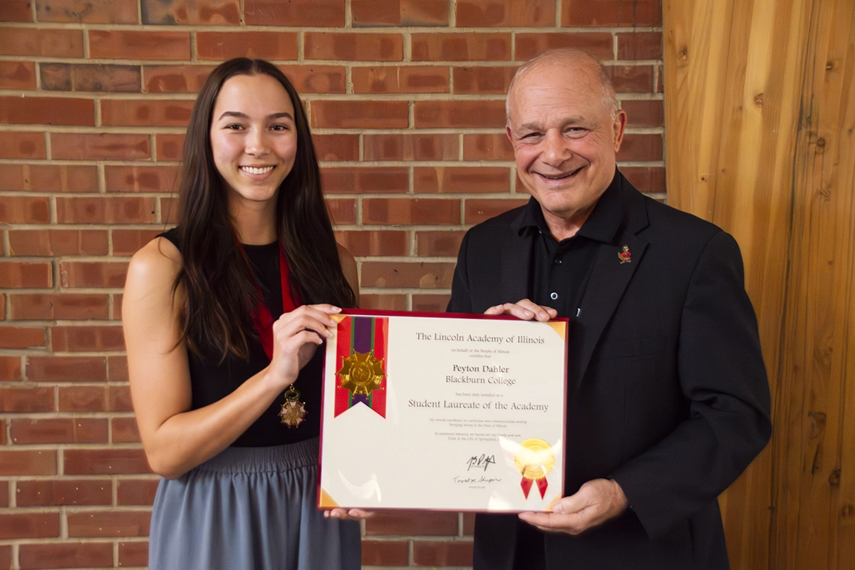 Peyton Dahler with President Larry K. Lee holding Lincoln Student Laureate certificate