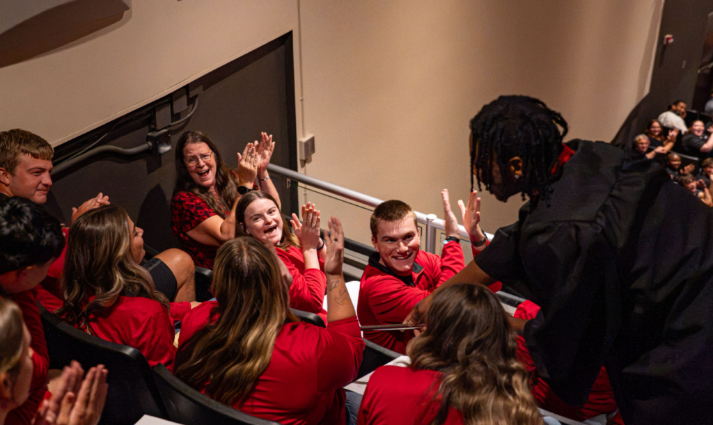 Former Student Marshal Darius Duff '26 taps the new student new Student Marshal, Rylee Lovelace